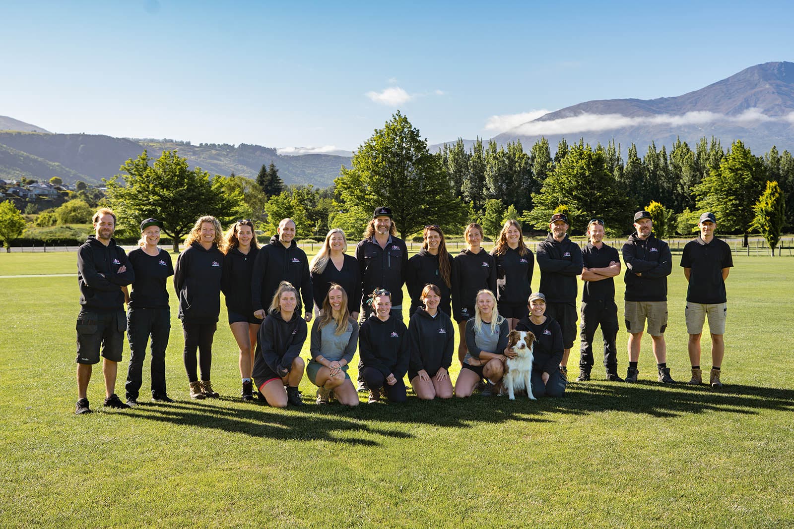 The Diva Landscapes crew together on a lawn, with the Whakatipu hills behind