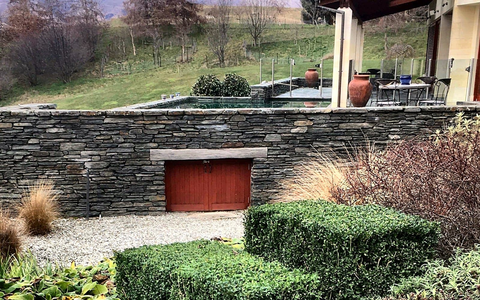 The same terrace garden after Diva's care: hedges clipped into crisp forms and beds cleared and tidied